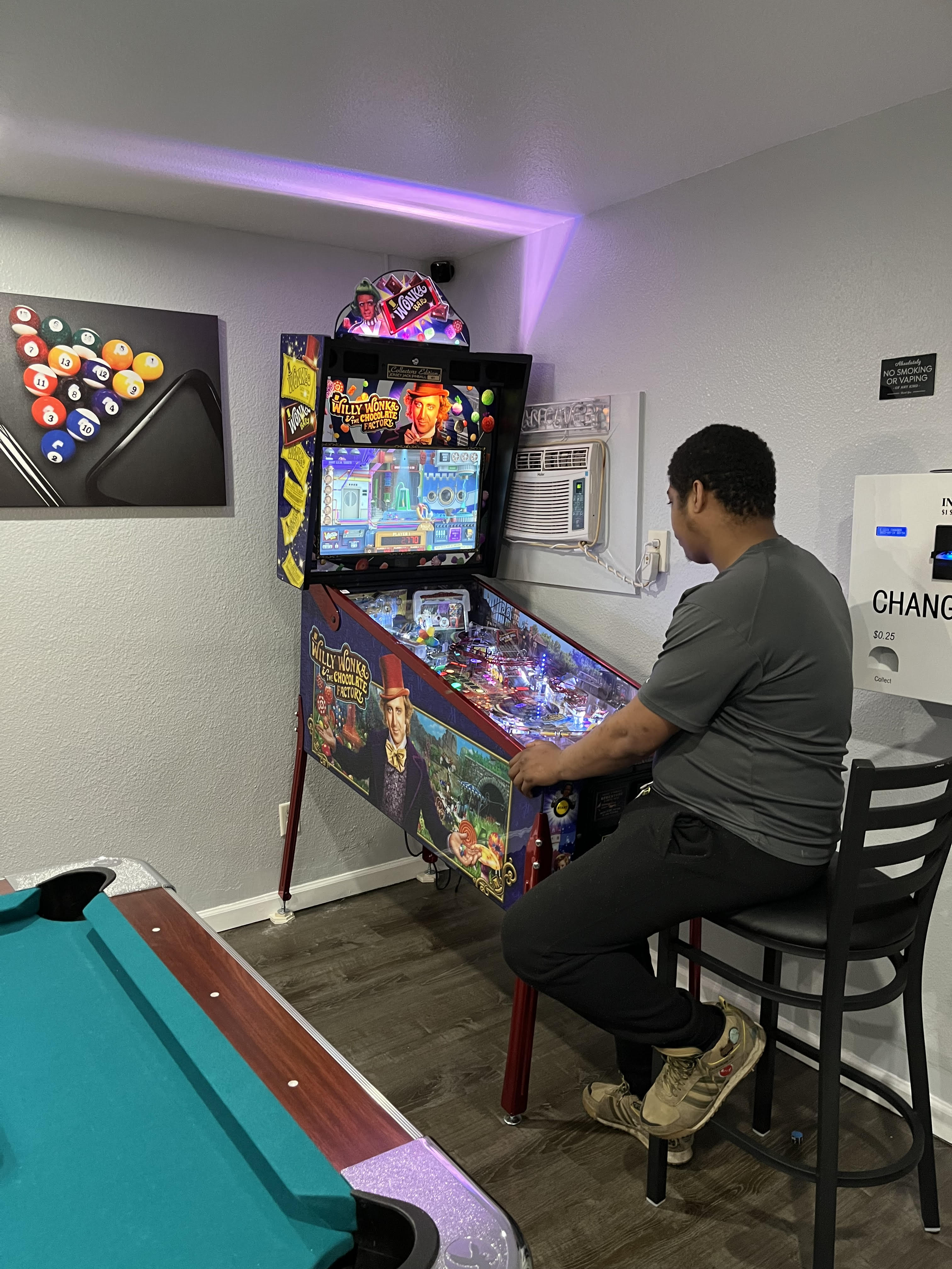 Man Playing Pinball Game